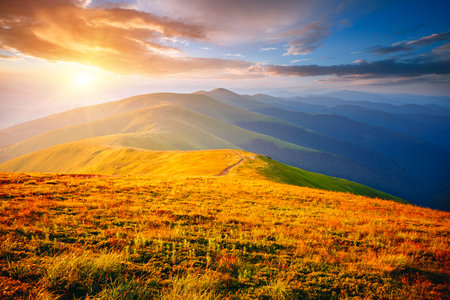 Stunning evening landscape in the mountains illuminated by the sun. Location place Carpathian mountains, Ukraine, Europe. Gorgeous wallpaper. Image of an magical sunset. Discover the beauty of earth.の写真素材