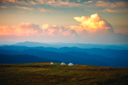 Attractive sunset in high mountains with camping on top. Location place Carpathian mountains, Ukraine, Europe. photo wallpaper. Adventure outdoor summer holidays. Discover the beauty of the world.の写真素材