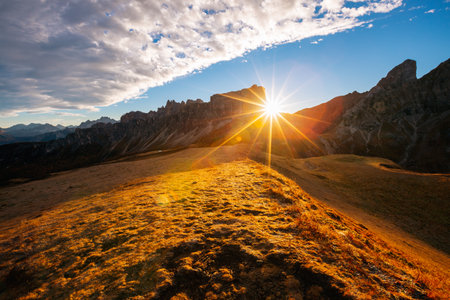 Magical morning sun illuminates the mountain slopes on the Passo di Giau. Location place Dolomiti Alps, Cortina d'Ampezzo, South Tyrol, Italy, Europe. photo wallpaper. Discover the beauty of earth.の写真素材