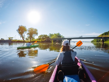 Group of people having fun kayaking on the river. Location place Seret, Ukraine. Active recreation in the open air. Outdoor summer vacations. Holiday travel activities. Discover the beauty of earth.の写真素材