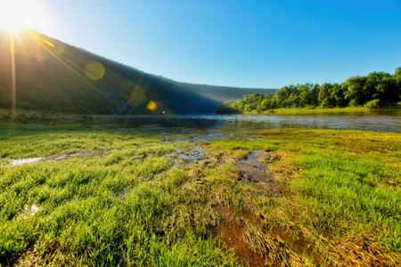 Summer morning with fresh green meadow on the river. Location place Dnister or Dniester canyon of Ukraine, Europe. Vibrant photo wallpaper. Splendid nature photography. Discover the beauty of earth.の写真素材