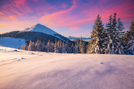 Splendid sunset in the mountains on a frosty evening. Location place of Carpathian mountains, Ukraine, Europe. Picturesque wallpapers. Photo of winter vacation. Happy New Year! Beauty of earth.の写真素材