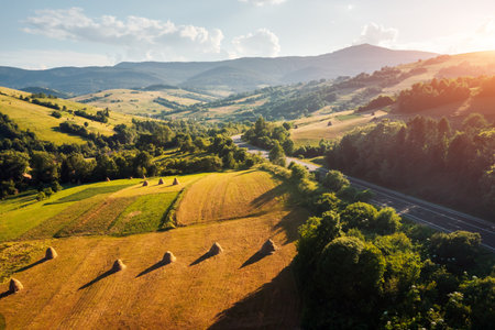 Rural area with green meadows from a bird's eye view on a sunny day. Location place Carpathian mountains, Ukraine, Europe. Tranquil sunshine vibe.の写真素材