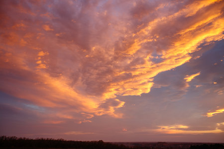 Fabulous and spectacular vivid clouds illuminated by the rays of the sun. Scenic image of textured sky. Perfect wallpaper. Photo of fiery orange sunset. Bright epic sky pattern. Beauty of earth.の写真素材