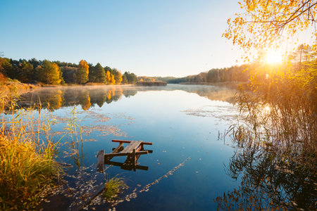 A magical autumn day on a quiet lake surrounded by a forest. Location place Small Polissya, Ukraine, Europe. Fresh and bright colors on the lake.の写真素材