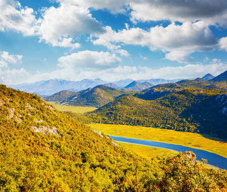 Picturesque view of the meander of the Rijeka Crnojevica on a sunny day. Location place National park Skadar Lake, Montenegro, Balkans, Europe. Vibrant photo wallpaper. Discover the beauty of earth.の写真素材