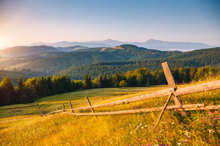 Morning sunlight illuminates the mountain ranges. Location place Carpathian mountains, Ukraine, Europe. Vibrant photo wallpaper. Summer holiday destinations. Explore the beauty of earth.の写真素材