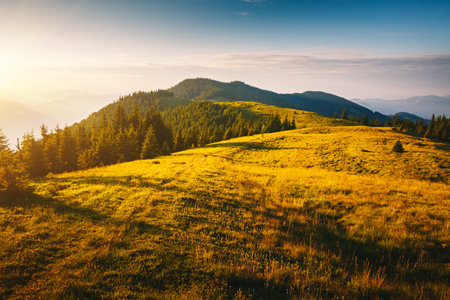 Morning sunlight illuminates the mountain ranges. Location place Carpathian mountains, Ukraine, Europe. Vibrant photo wallpaper. Summer holiday destinations. Explore the beauty of earth.の写真素材