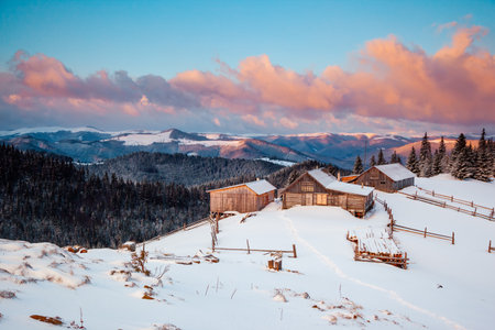 Snow-capped mountain huts in the frosty day. Location place Carpathian mountains, Ukraine, Europe. Vibrant photo wallpaper.の写真素材