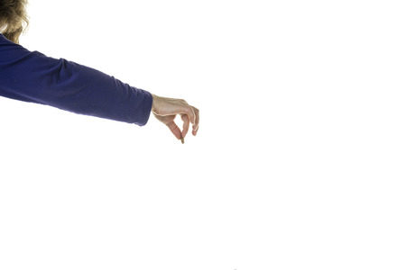 Human hand and arm with a blue sleve holding a pet treat isolated in a white backgroundの写真素材
