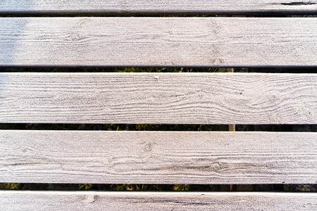 Wooden planks with a frozen layer of icecrystals backgroundの写真素材