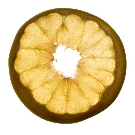 Slice of pomelo fruit with light shining through backlight showing the structure and details isolated on a white backgroundの写真素材
