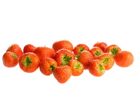 Fresh strawberries lying in a group isolated on a white backgroundの写真素材