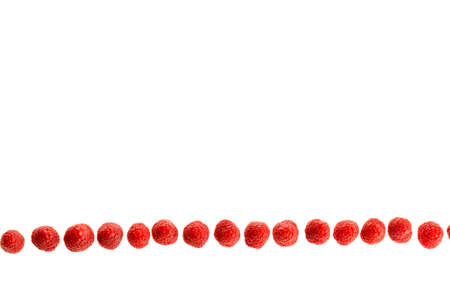 Ripe raspberries lying lined up seen from above isolated in a white background