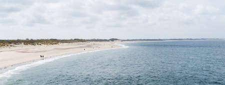 Seaview and beach at the estuary of the Oosterschelde area in The Netherlands Zeeland seen from the Oosterschelde barrierの写真素材