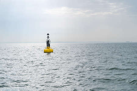 An Electric bollard light or buoy on the open sea in the esuary of the Thames, England, UK with the...