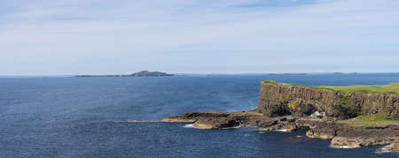 A Panoramic view on Staffa Island and Fingals Cave or The Giants Causeway off the coast of Scotlandの写真素材