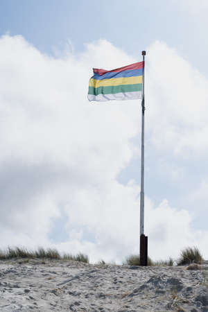 The Flag of Terschelling - one of the Wadden islands in The Netherlands - flying on the sand duneの写真素材