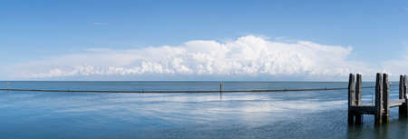 Panorama A Remote floating landing stage for a ferry boat or jetty at a calm sea with an impressinve cloudy skyの写真素材