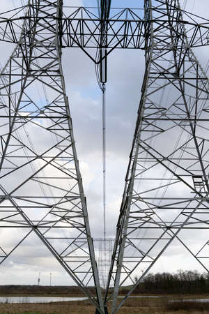 High-Voltage Mast or pylon with powerlines to transport electricityの写真素材
