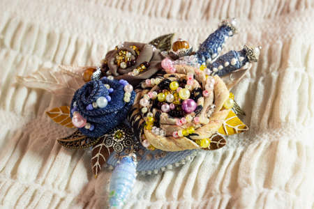 Textile brooch with embroidered flowers
