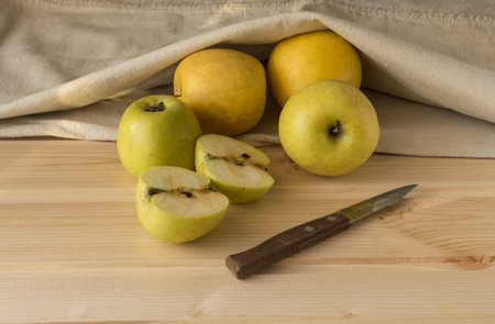 apples whole and cut plank knife and bagの写真素材