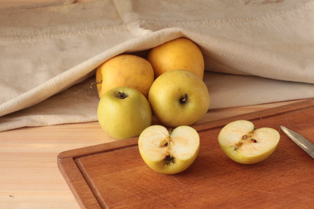 apples whole and cut plank knife and bagの写真素材