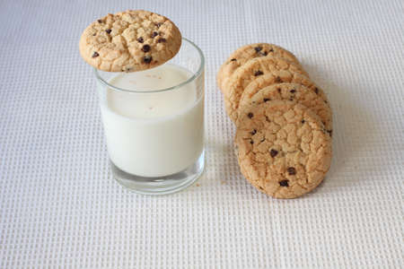 snack healthy cookies with milk on white tableclothの写真素材