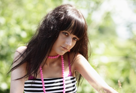 Portrait of the nice girl on the nature at a bright back sunlightの写真素材