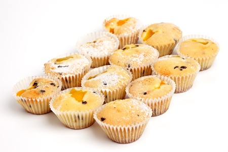 Batch of apricot fruitcakes on a white backgroundの写真素材