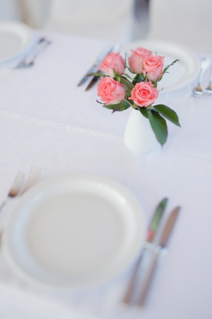 Bouquet of roses on a table in wedding day, table setting. Selective Focus.の写真素材