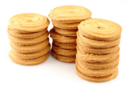 sugar cookies arranged in three stacks on a white backgroundの写真素材