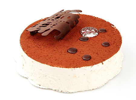 Christmas cake covered with cocoa and decorated with chocolate on a white backgroundの写真素材