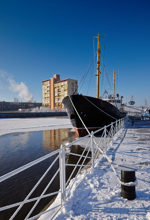 Fishing trawler moored at the pier in winter. Koenigsberg, Kaliningrad, Russia.の写真素材