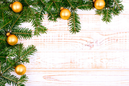 Christmas fir tree on white wooden background.の写真素材