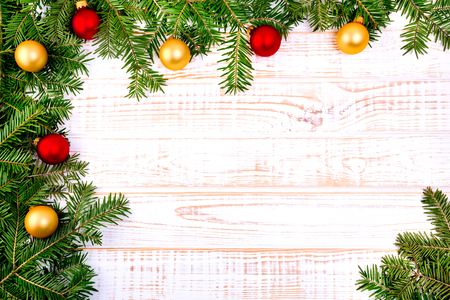 Christmas fir tree on white wooden background.の写真素材