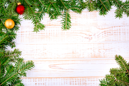 Christmas fir tree on white wooden background.の写真素材