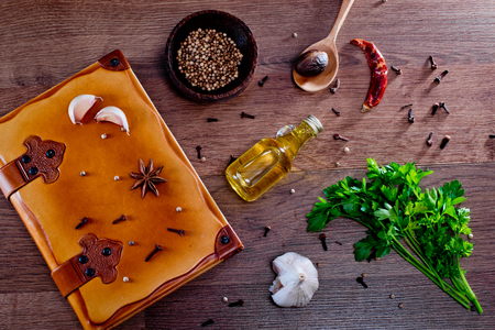 Top view on note book, parsley and spices on a wooden background.の写真素材