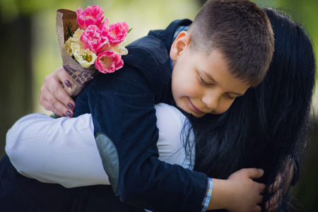 Little cute boy hug with her mom in park.  Family photo session.の写真素材