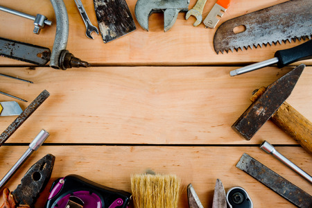 Old manual tool on a wooden background with copy space.