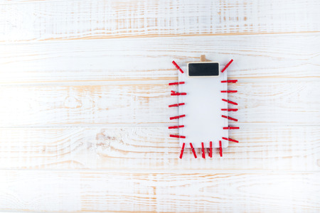 Shopping list on white wooden background.の写真素材