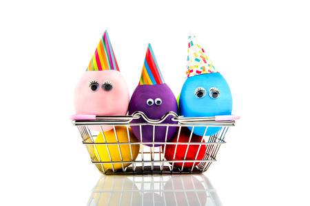 Funny handmade eggs in metal shopping basket isolated on white background. Easter holiday.の写真素材