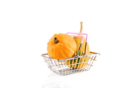 Metal shopping basket with two pumpkins isolated on white. の写真素材