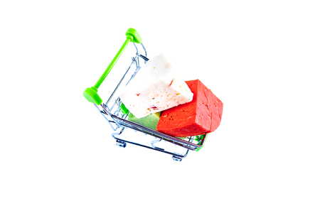 Various types of cheese in metal shopping cart isolated on white background. の写真素材