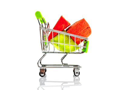 Various types of cheese in metal shopping cart isolated on white background. の写真素材