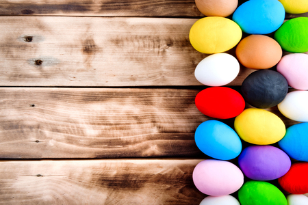 Colorful easter eggs old brown wooden board. Easter postcard.の写真素材