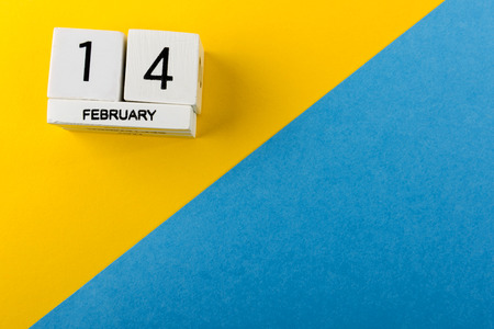14th february, calendar on blue and yellow background with copy space. Valentine's Day.の写真素材