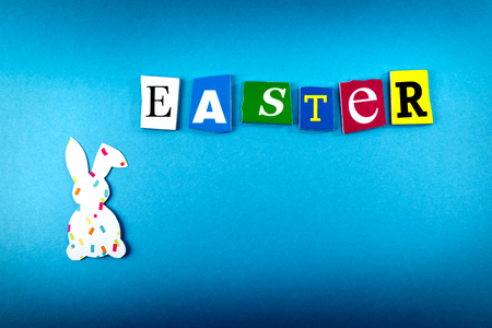 Easter inscription with bunny on blue background. Top view. Easter postcard.の写真素材