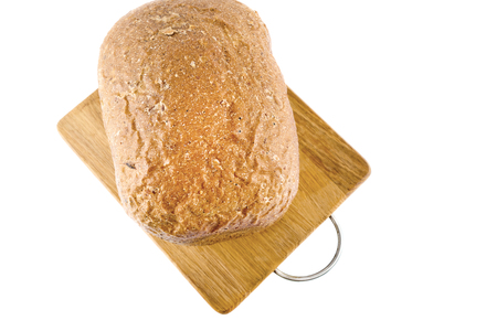 Freshly baked bread on wooden cutting board isolated on white background. Top view.の写真素材