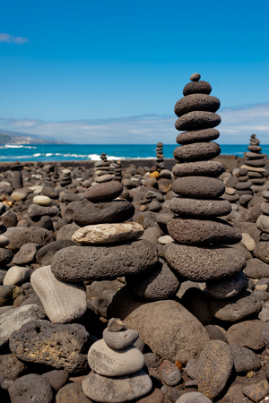 Stack of stones on the sea beach. Tenerife.の写真素材